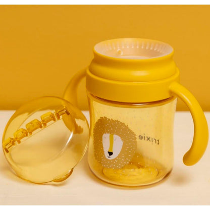 Consigue el Vaso Anti-derrame 360 León de Trixie. Taza de aprendizaje infantil con asas, hecha de Tritan™ resistente. Perfecta para beber de forma autónoma y sin derrames.