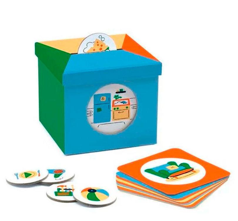 juego educativo kioukoi Maison es una caja de cartón robusta con forma de hucha construida en varios colores con tarjetas semánticas y fichas de cartón redondeadas con pictogramas de la casa djeco