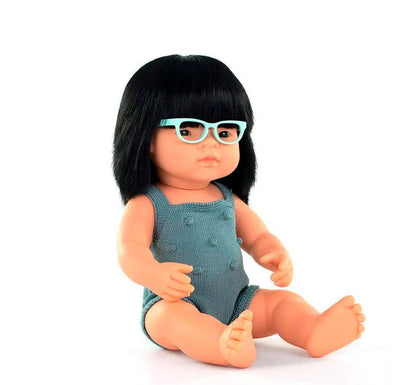 Esta muñeca es una niña asiática con pelo liso negro y gafas,  con un adorable pelele azul petróleo. Perfumadas ligeramente a vainilla,  sentada