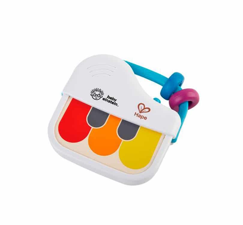 priano de mano en blanco y tres teclas de colores naranja, amarillo y rojo de la marca HAPE